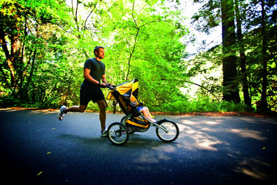 man jogging with kid in stroller