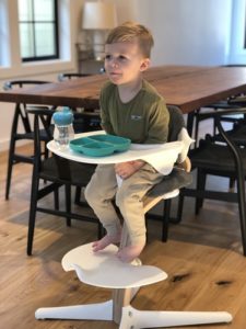 kid eating in nomi chair