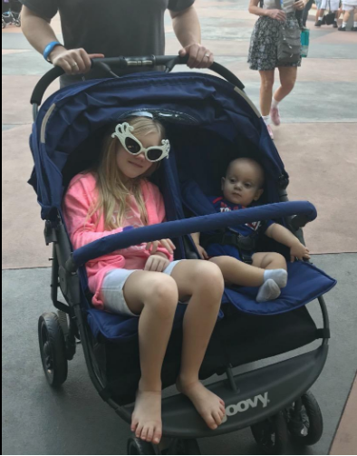 Kid and infant in double stroller