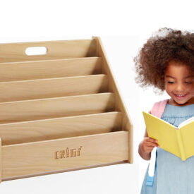 kid next to montessori bookshelf